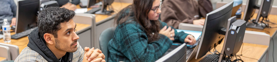 A group of students listening to a lecture in a classroom.