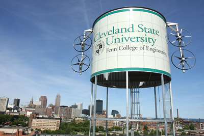 Cleveland State University's wind amplification turbine system is prominently displayed on the rooftop of its Plant Services Building located at the corner of Chester Ave. and E. 24th Street. The patented system, designed by Dr. Majid Rashidi of CSU’s Fenn College of Engineering, is a wind-deflecting cylinder structure with small-scale turbines on its sides that can generate power at low wind speeds.