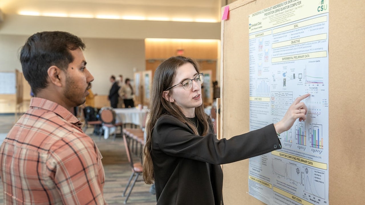 Student presenting research to faculty