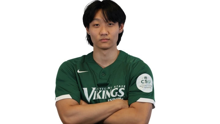 Esports player Matthew crossing his arms