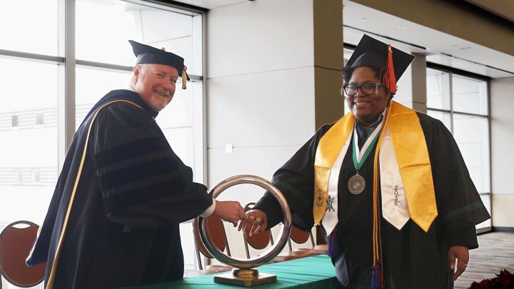 Dean Richard shaking student's hand