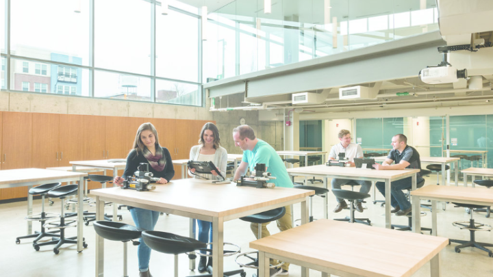 A wide shot of students in a well-lit lab.