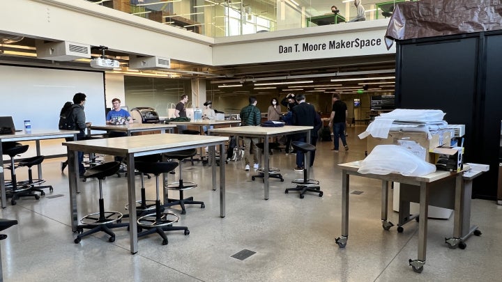 A wide shot of the Makerspace featuring students interacting with AR and VR equipment.