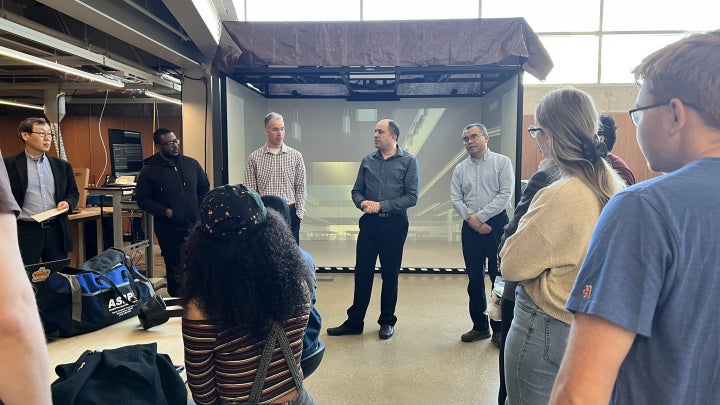 Professors presenting AR and VR equipment to students in the Makerspace Lab.