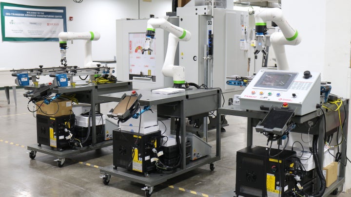 Three robotic arm equipment's in a laboratory.