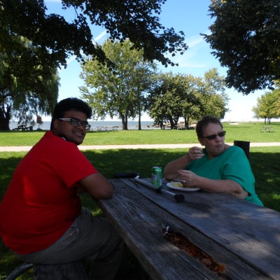 Becky Laird at her friend sitting at a bench in Edgewater Park picnic.