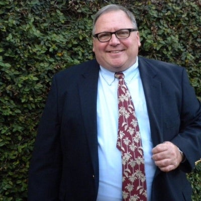 Thomas Bell posing for a photo outdoors.