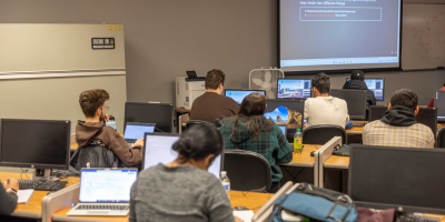 A classroom full of students in a lecture.
