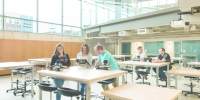 A wide shot of students in a well-lit lab.