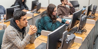 A group of students listening to a lecture in a classroom.