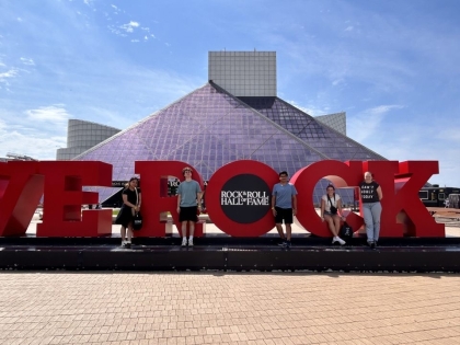 Students standing on Rock and Roll Sign at Rock and Roll Hall of Fame