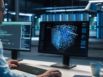 Man at computer station - quantum computing