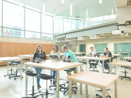 A wide shot of students in a well-lit lab.