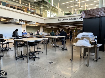 A wide shot of the Makerspace featuring students interacting with AR and VR equipment.