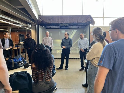 Professors presenting AR and VR equipment to students in the Makerspace Lab.