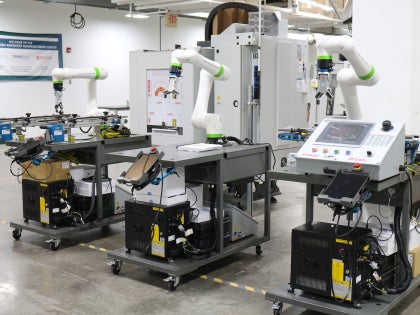 Three robotic arm equipment's in a laboratory.