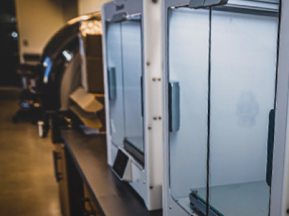 3d printers on a table in a lab.
