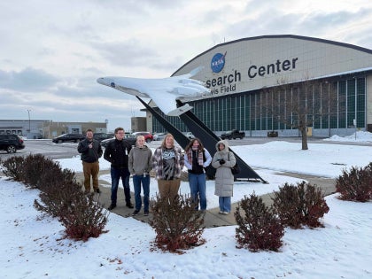 A group of students posing for a picture outside the NASA Glenn Research Center.