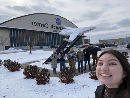A group of students posing for a picture outside the NASA Glenn Research Center.